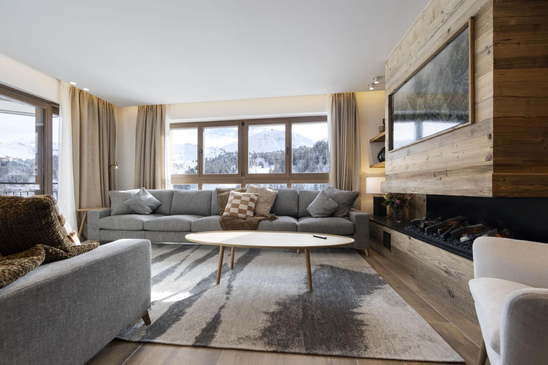 Living area with electric fireplace and mountain views