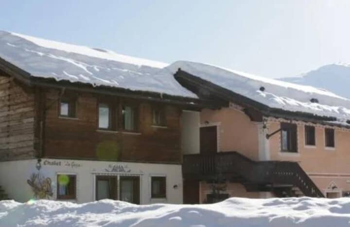 Chalet exterior with external wooden stairs leading to upper floor entrance
