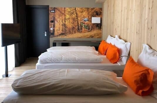 Bedroom with twin beds and mountain bike wall mural