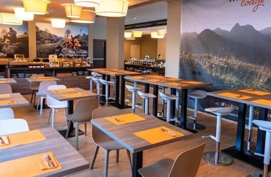 Shared dining area with high-top seating and breakfast buffet