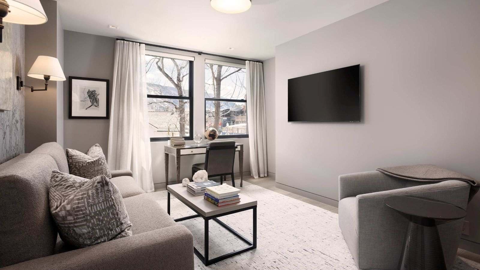 Sitting area with sofa bed, 55-inch TV, and workspace