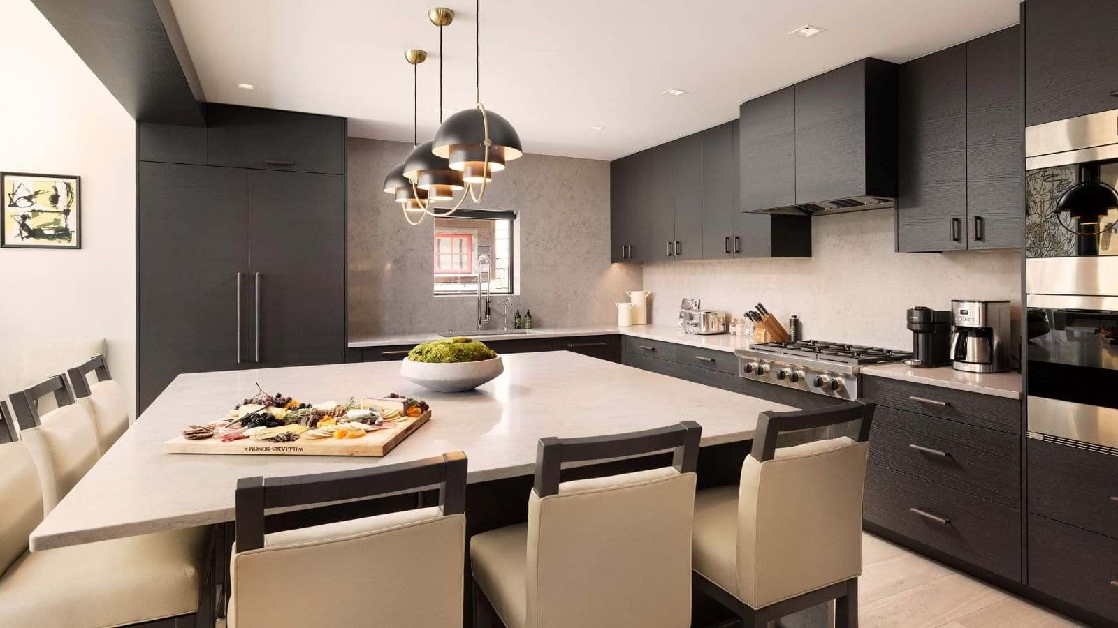 Kitchen with 6-burner gas range and oversized island seating for 6