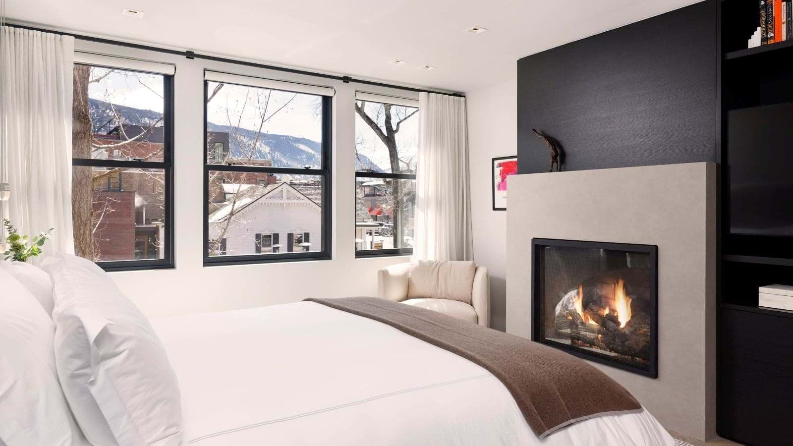 Primary bedroom with gas fireplace and mountain views