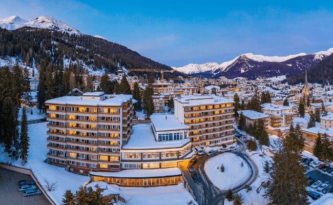 Building exterior with private balconies and snowy mountain views