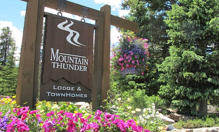 Mountain Thunder Lodge and Townhomes entrance sign with landscaped floral gardens