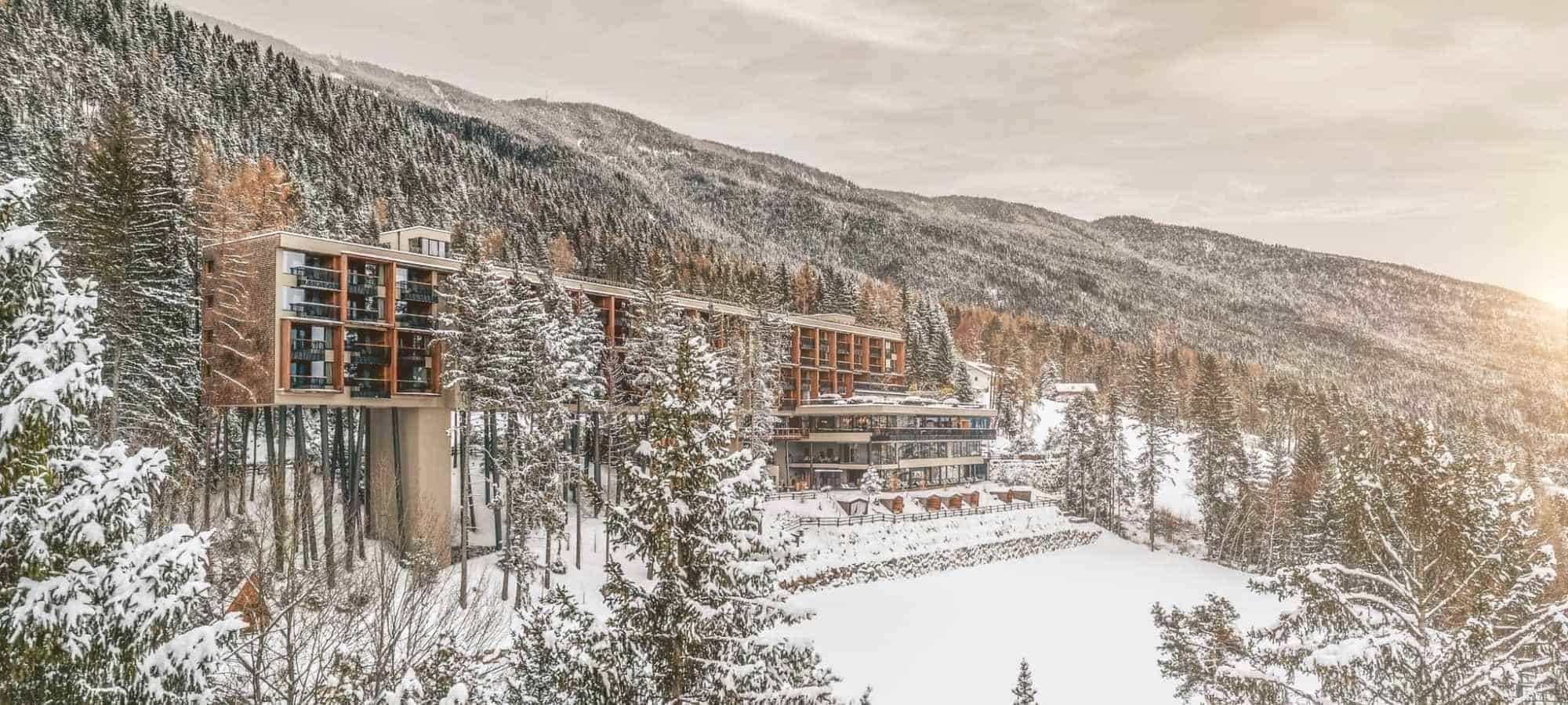 Ski-in/ski-out resort exterior with cantilevered wing over the forest floor