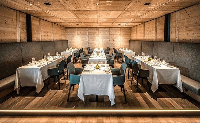 Private dining room with wood-paneled walls and seating for 24 guests
