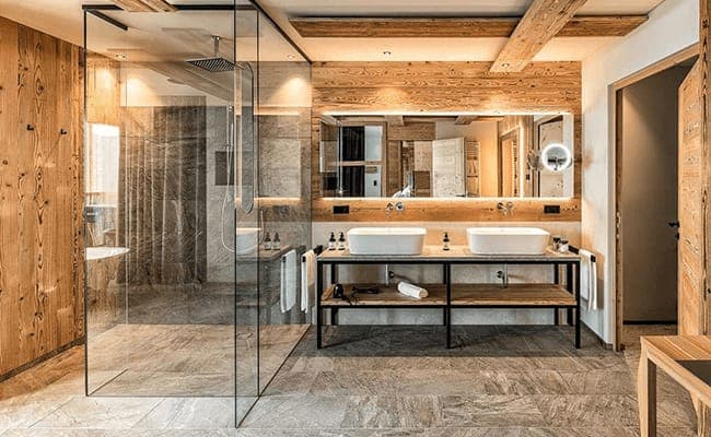 Bathroom with dual vessel sinks and walk-in rain shower
