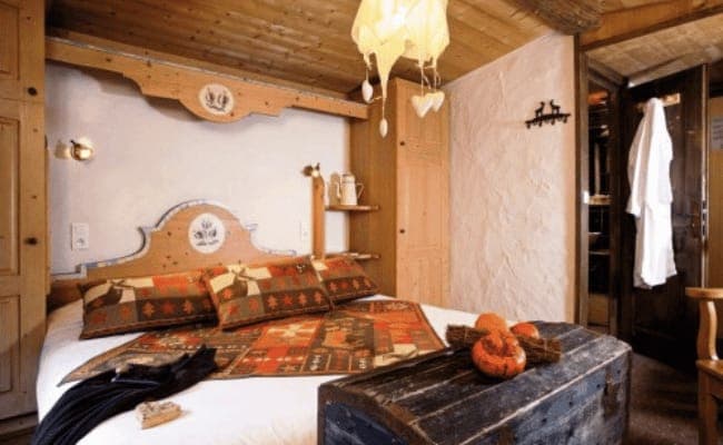 Bedroom with queen bed, ensuite access, and built-in closet storage