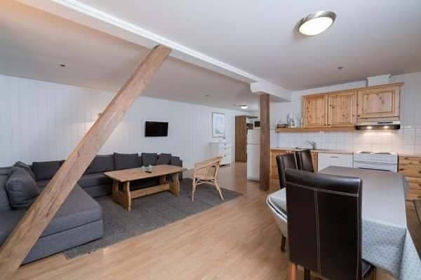 Open-plan living area with sectional sofa and dining seating for 6