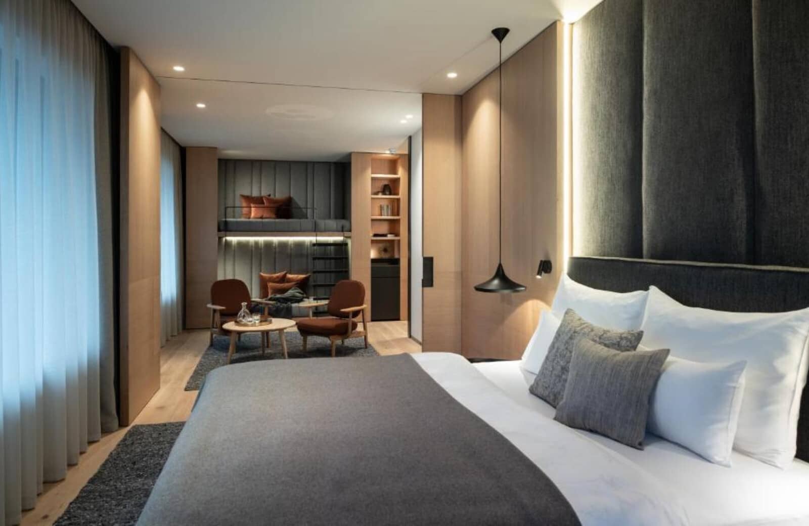 Family suite with king bed, lounge area, and twin bunk bed