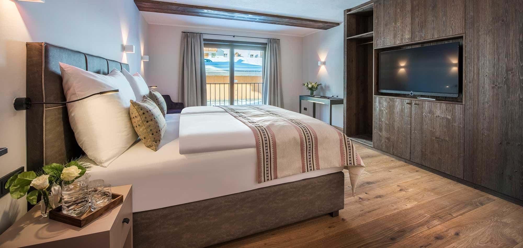 Bedroom with king bed and private balcony access