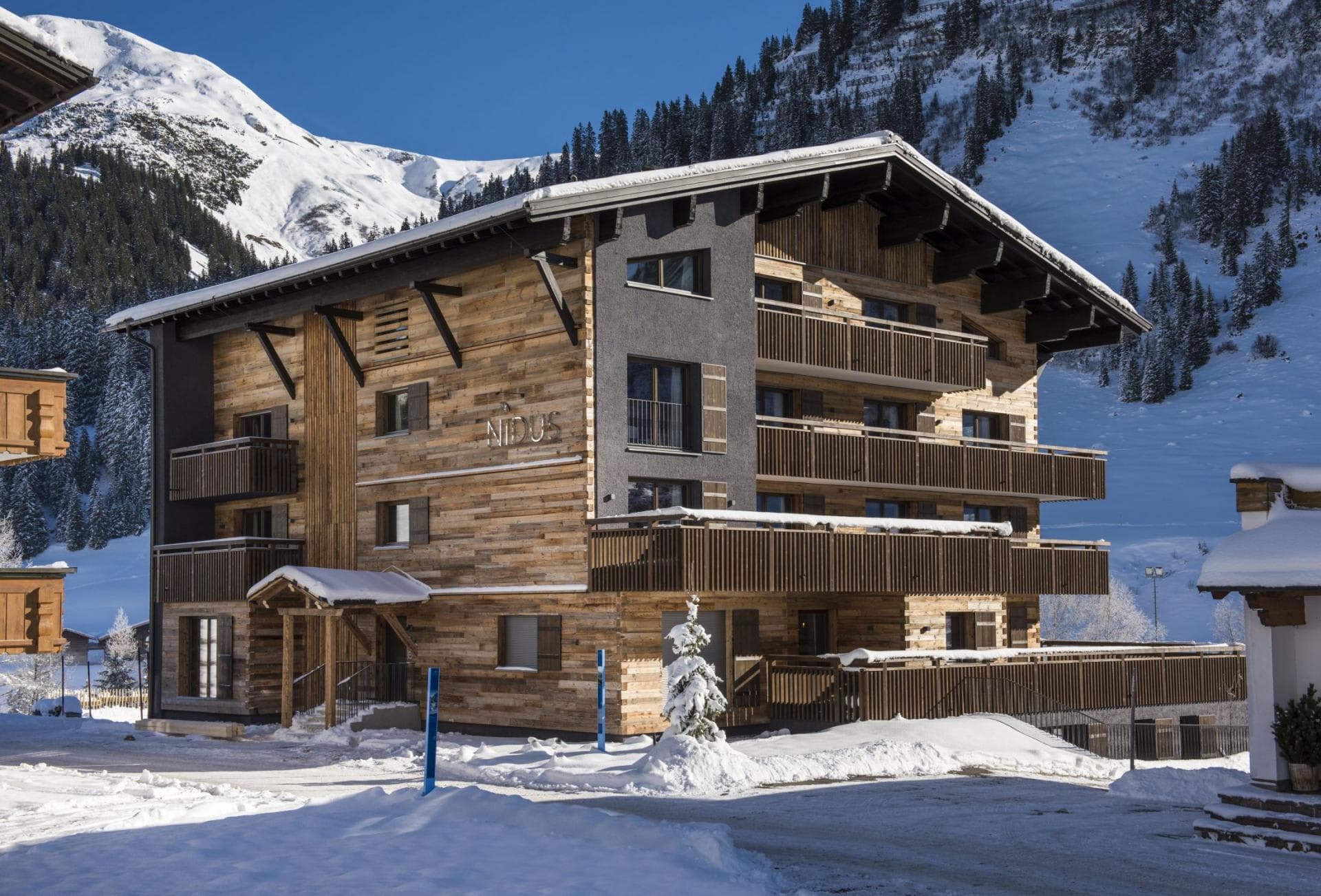 Chalet exterior with multiple private balconies and direct mountain access