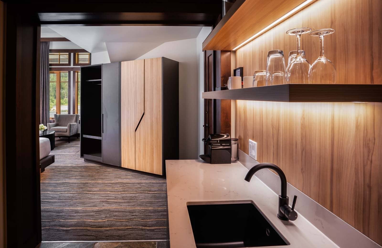 Wet bar with Nespresso machine and sink adjacent to bedroom