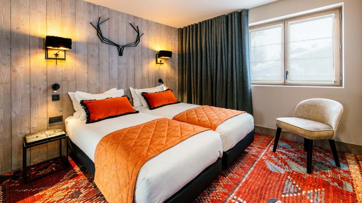 Guest bedroom with two twin beds and blackout curtains