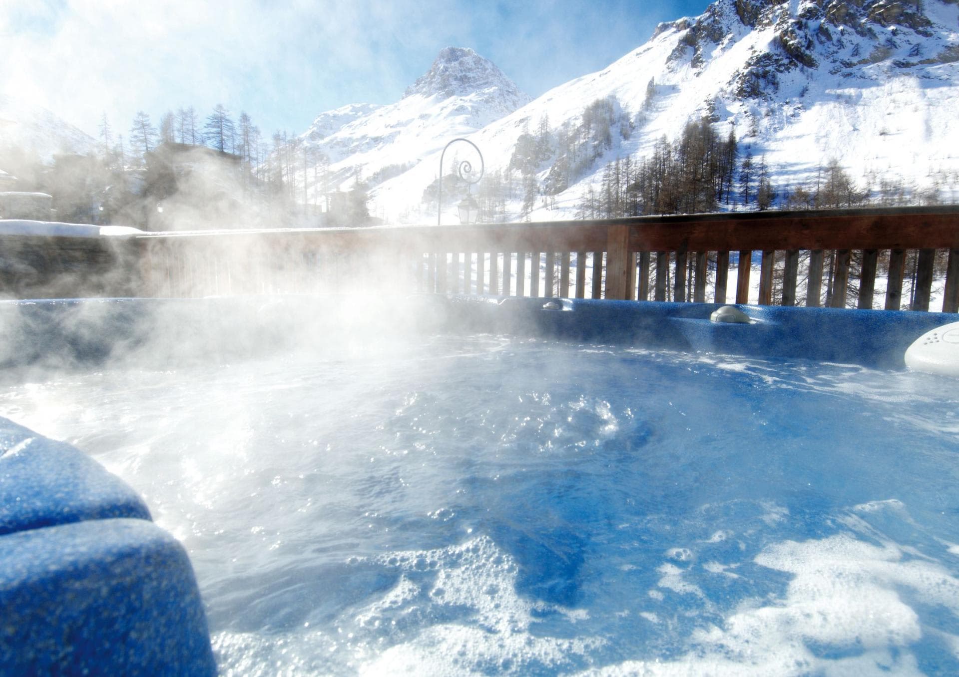 Outdoor hot tub with panoramic views of snow-capped mountains