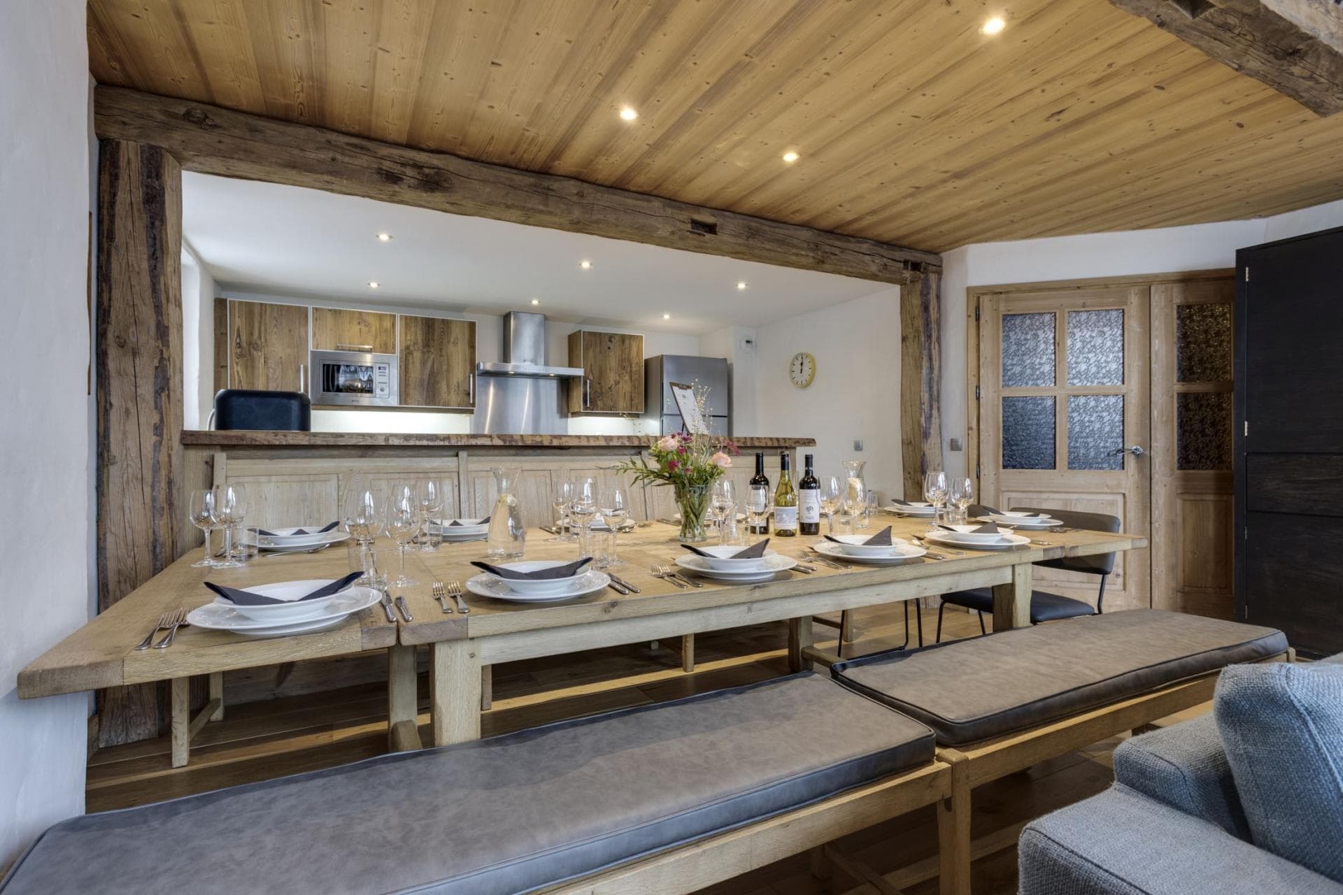 Dining area with seating for 10 adjacent to open-plan kitchen