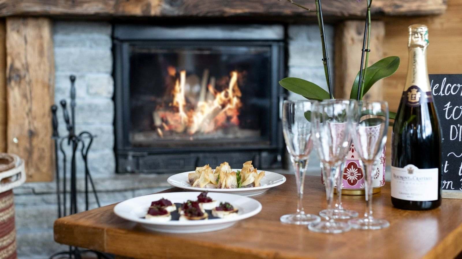 Wood-burning fireplace in living area with stone surround