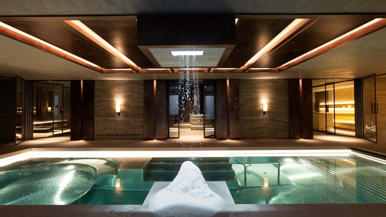 Indoor pool and spa area with ice fountain and rainfall shower
