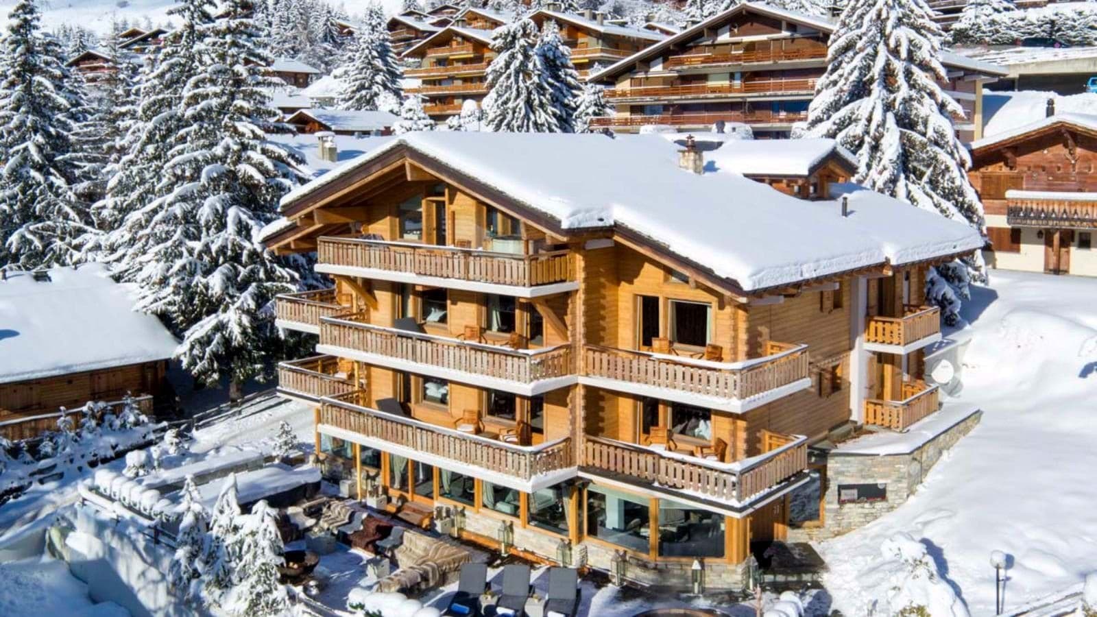 Ski-in chalet with wrap-around balconies and outdoor terrace lounge