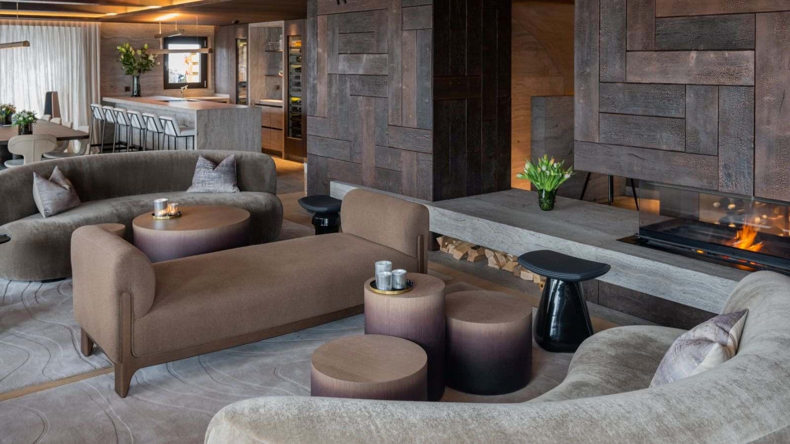 Living area with gas fireplace and breakfast bar seating in background