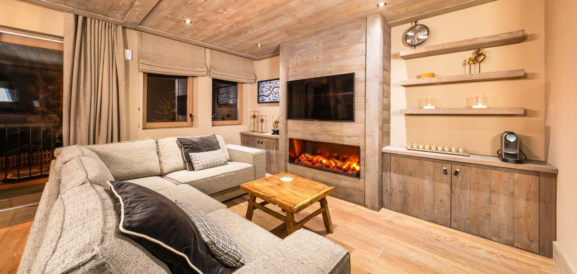 Living area with sectional seating, electric fireplace, and Nespresso coffee station