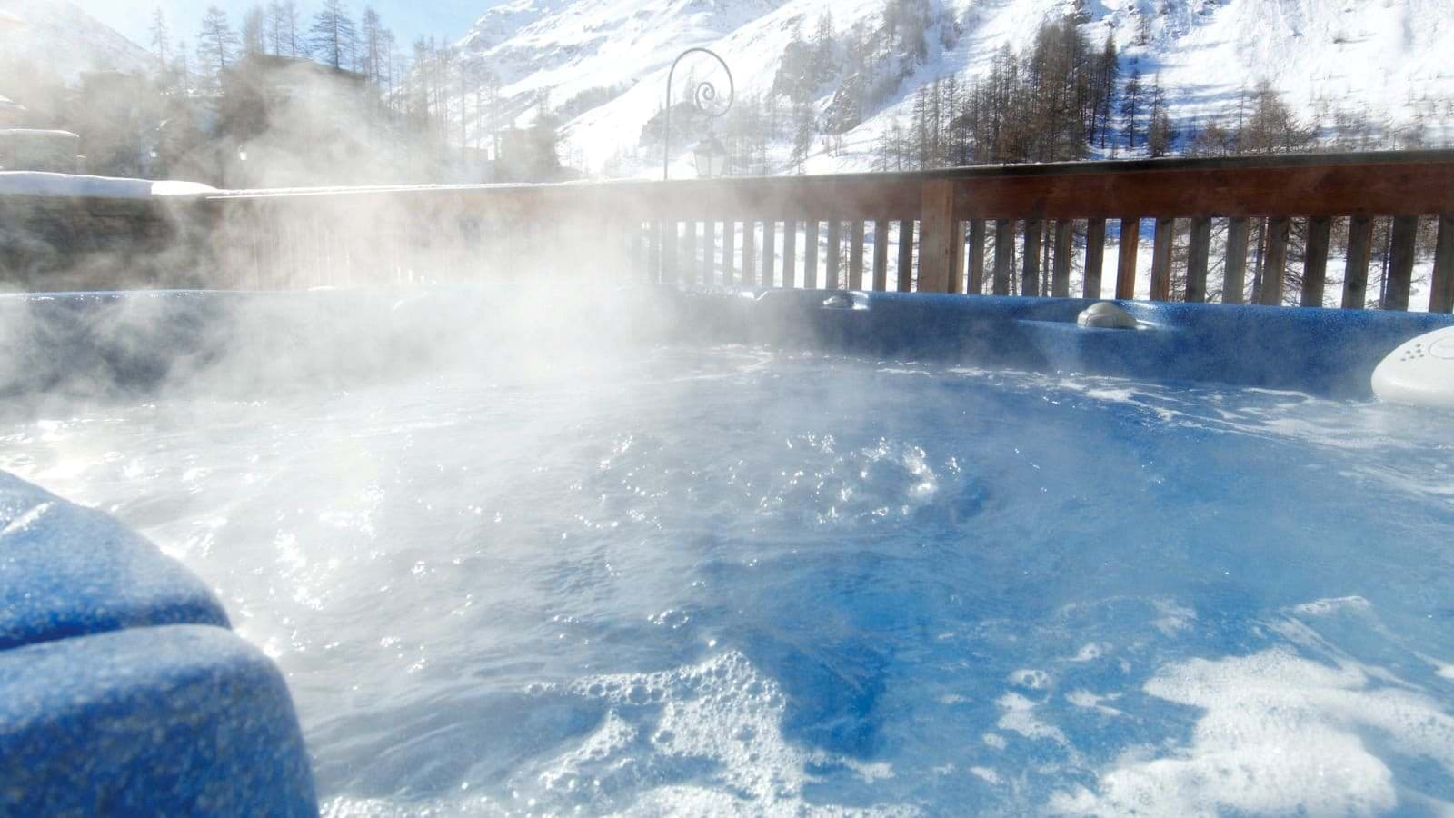 Outdoor hot tub with views of snow-covered mountains