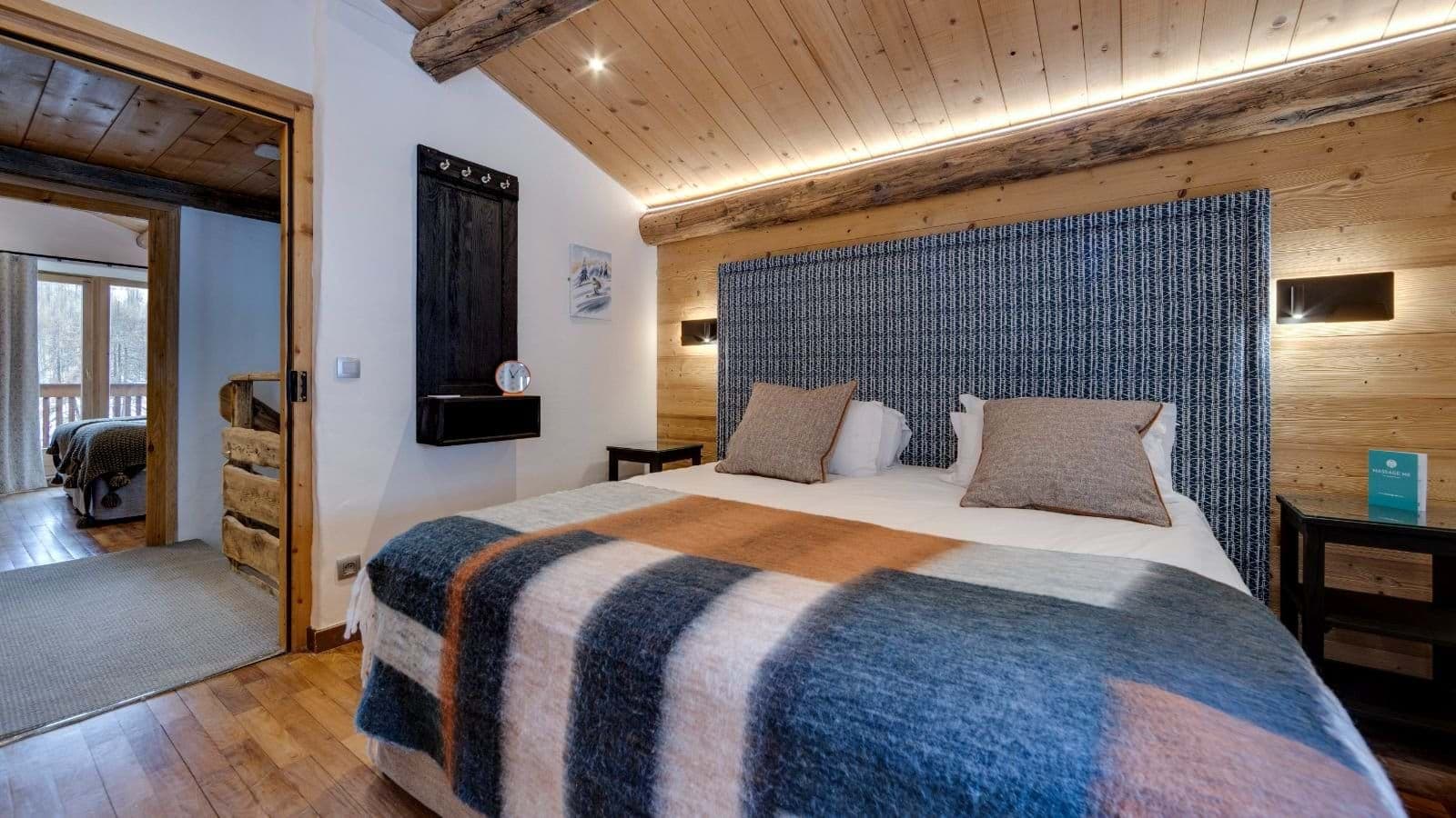 Bedroom with king bed and vaulted wood-beamed ceiling