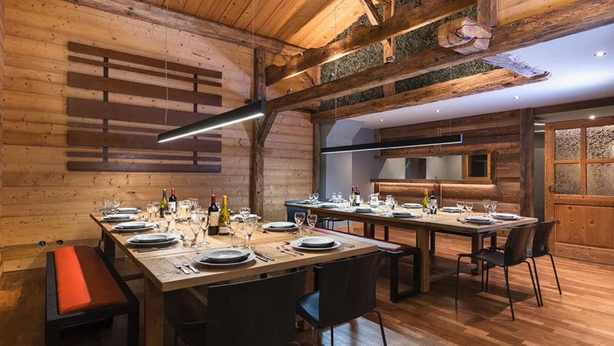 Dining area with dual tables seating 20; vaulted timber ceilings