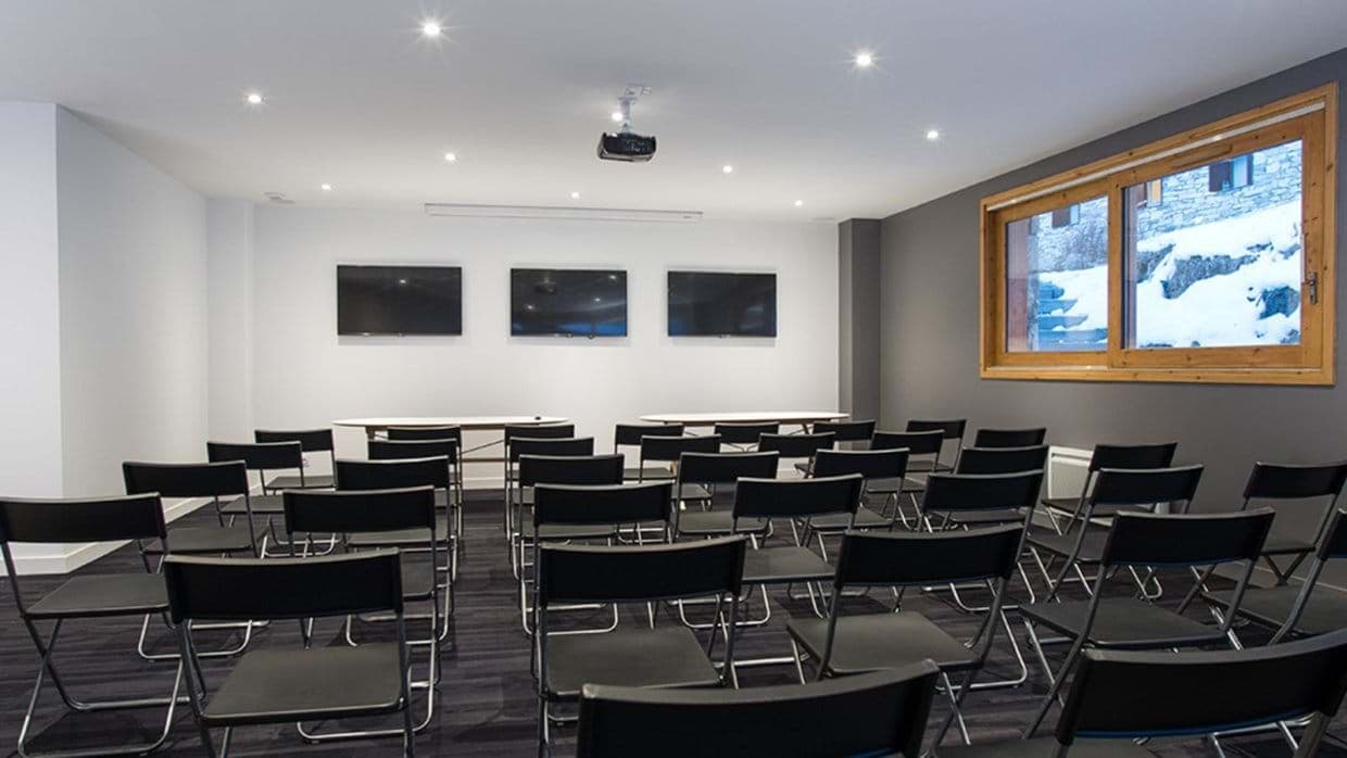 Conference room with projector, triple screens, and seating for 30