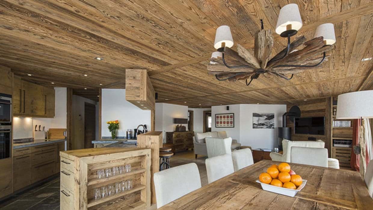 Open-concept living area with reclaim timber ceilings and wood-burning stove