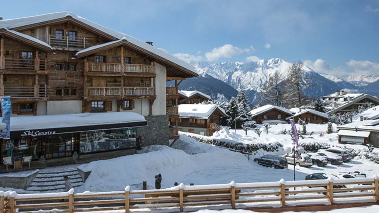 Chalet exterior with mountain views and on-site ski rental shop