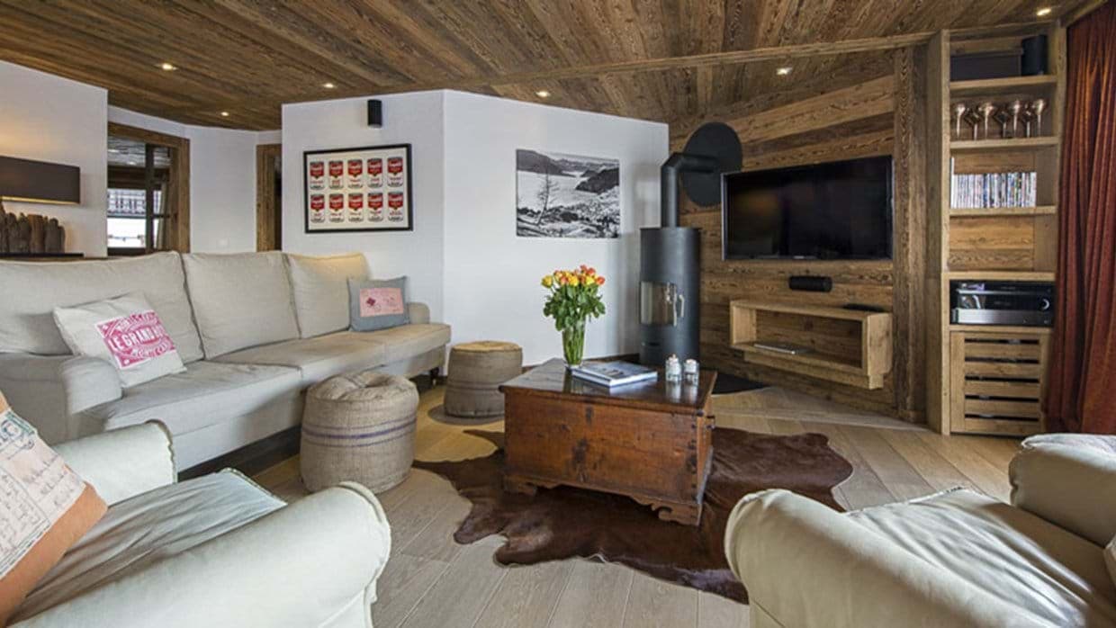 Living area with wood-burning stove and wall-mounted smart TV