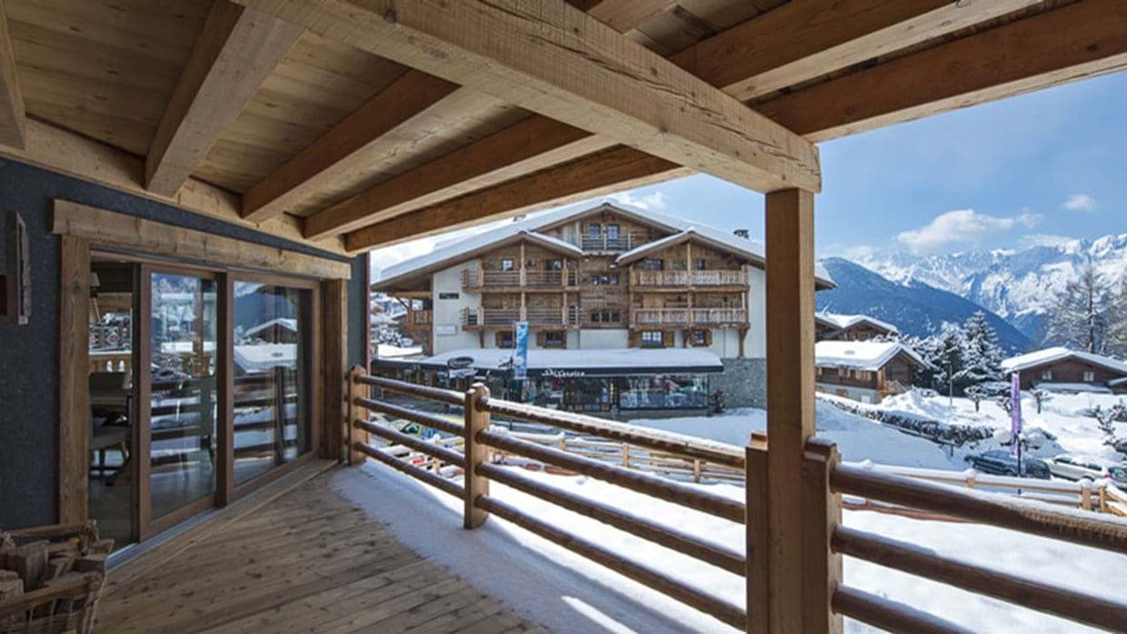 Covered timber balcony with village and mountain views