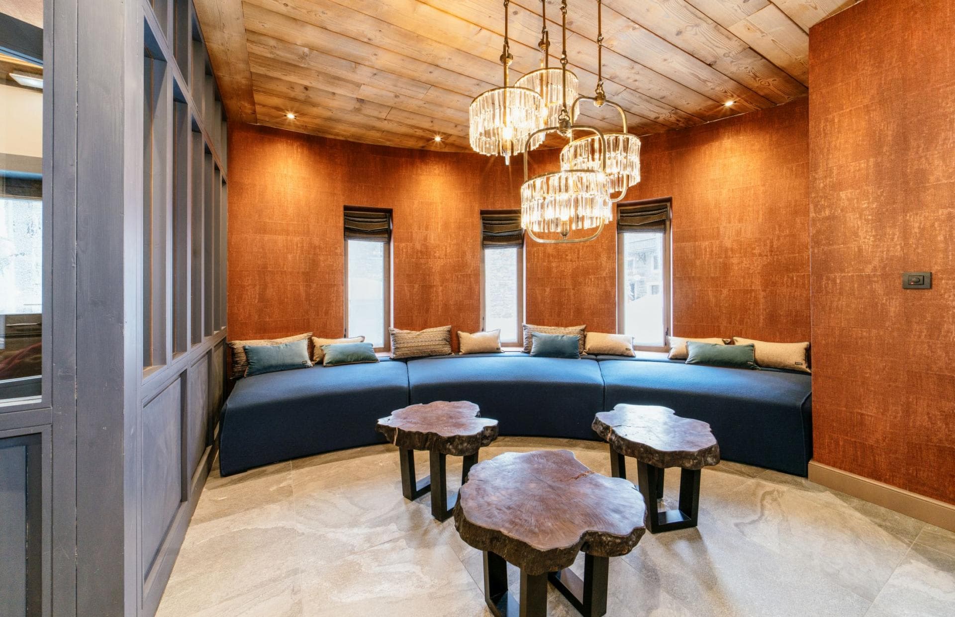 Lounge area with curved built-in sofa and live-edge tables