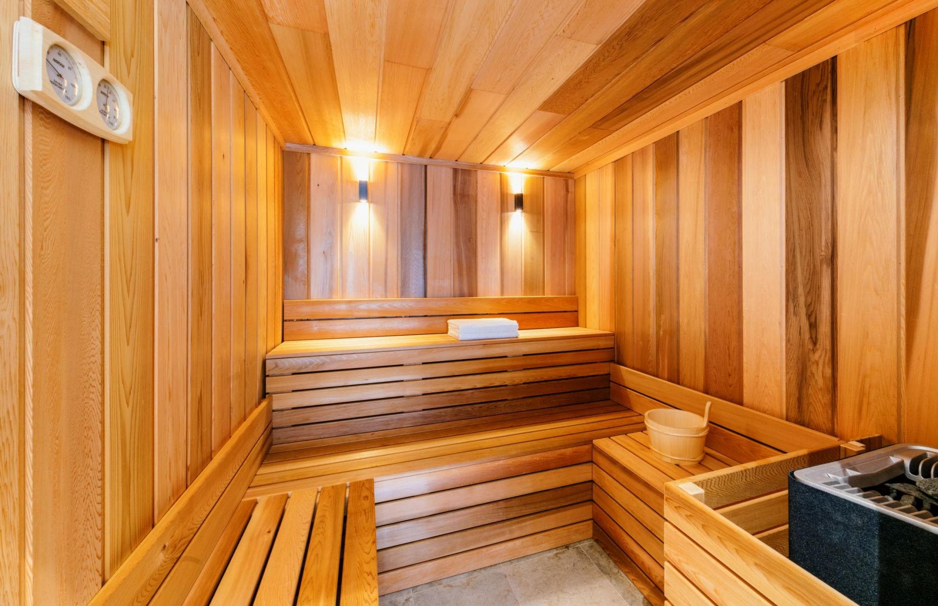 Private cedar sauna with two-tier seating and electric heater