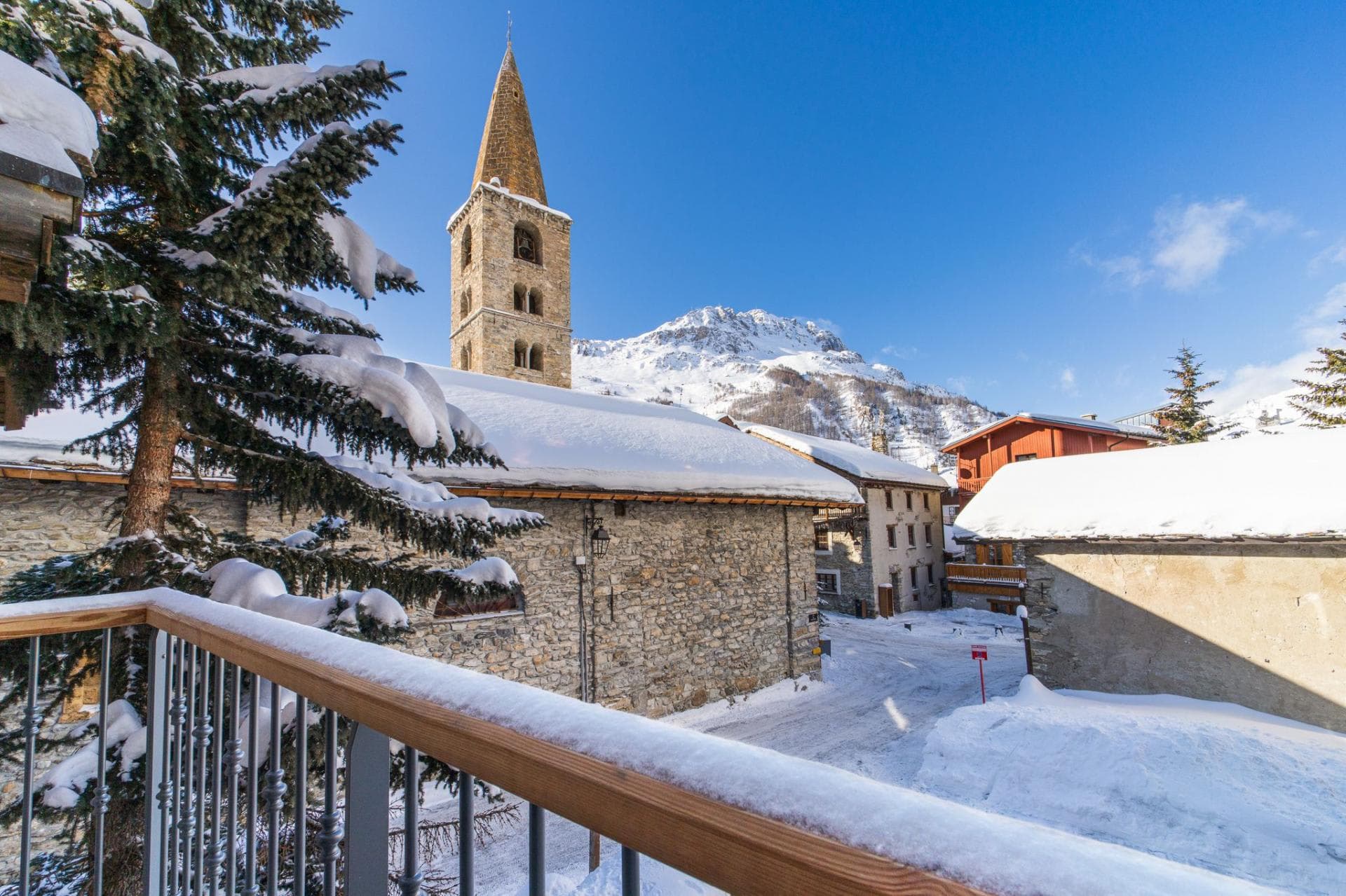 Private balcony with views of historic stone church and mountain peaks