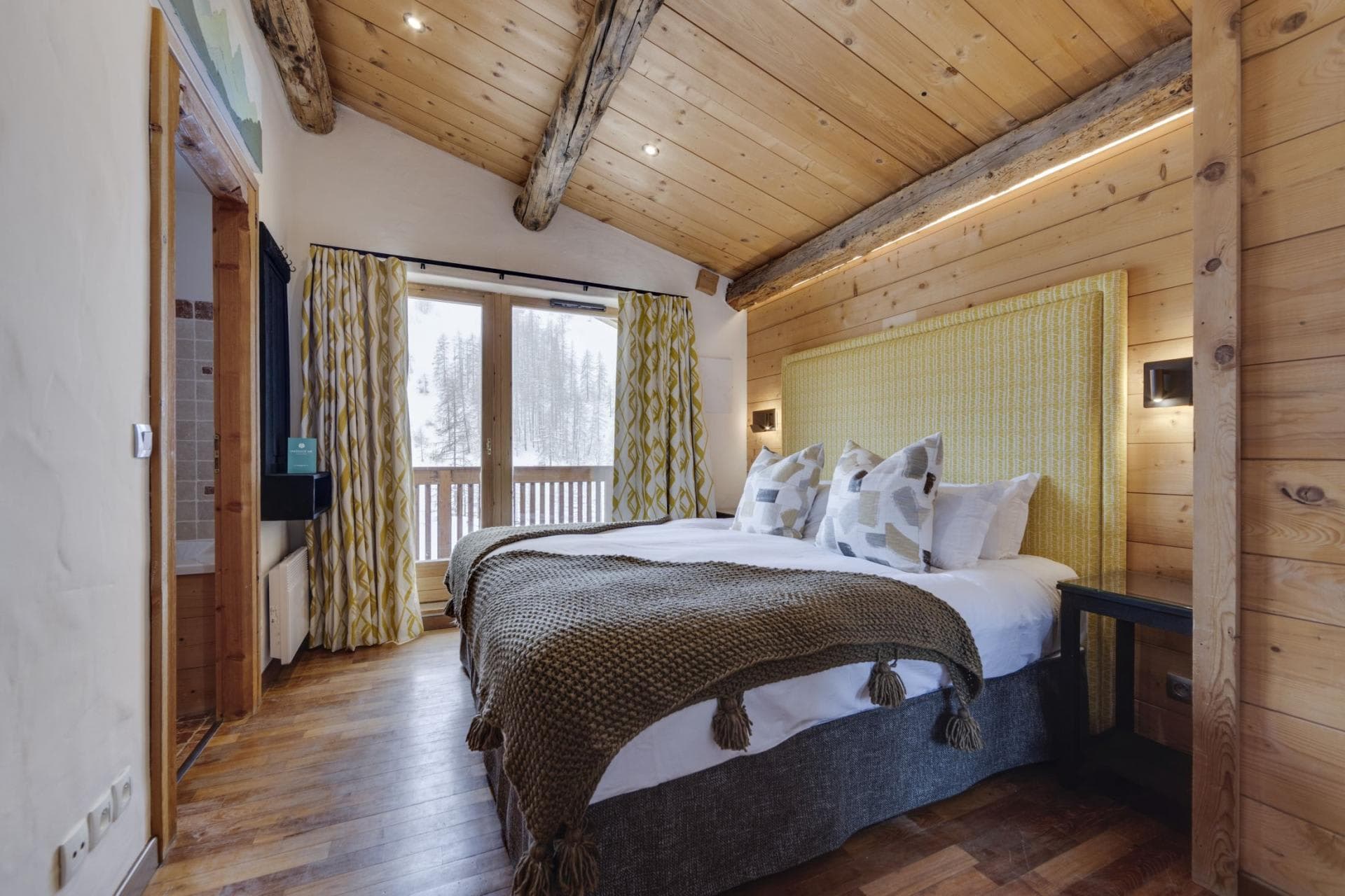 Primary bedroom with king bed, ensuite bath, and balcony access