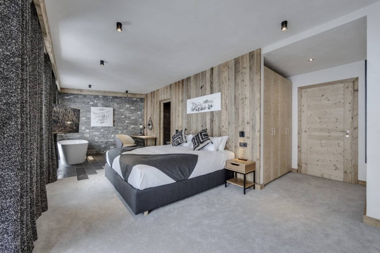 Primary bedroom with king bed and in-room soaking tub