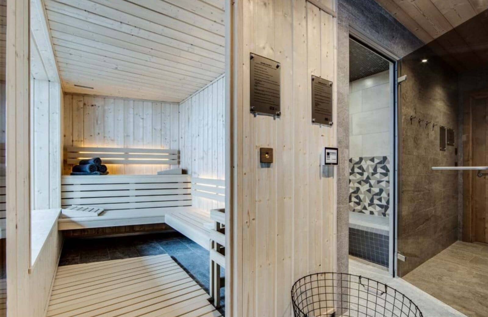 Private wood-paneled sauna with adjacent walk-in shower