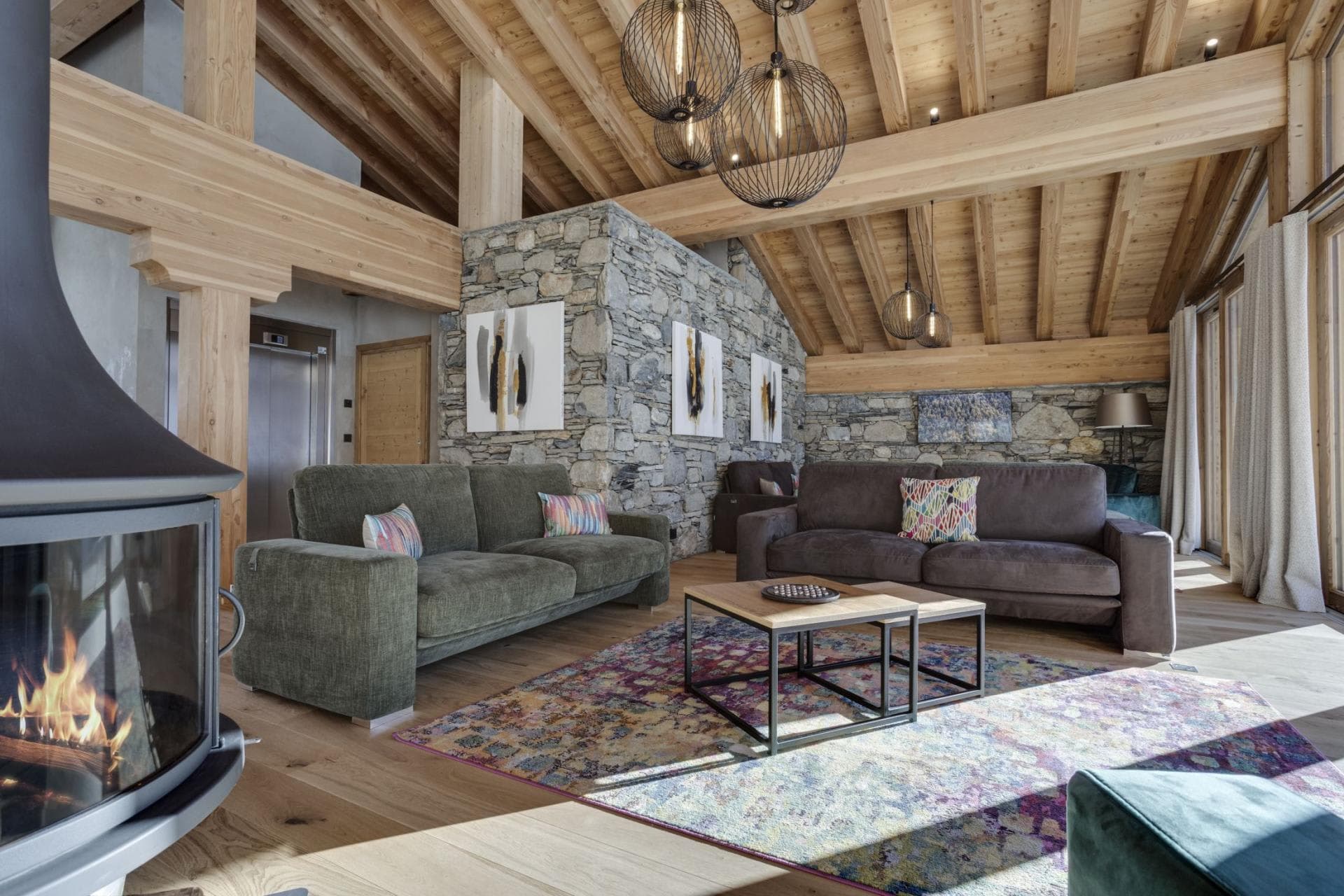 Living area with wood-burning stove and internal elevator access