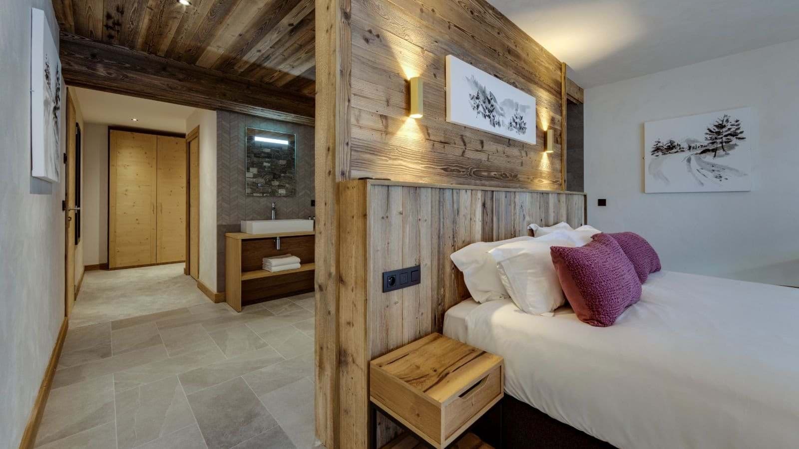 Primary bedroom with en suite vanity and walk-in wardrobe area