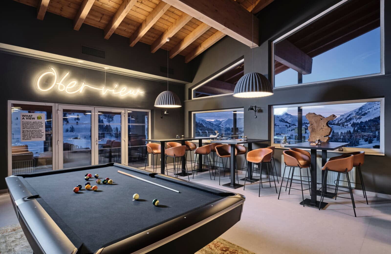 Game room with pool table, bar seating, and mountain views