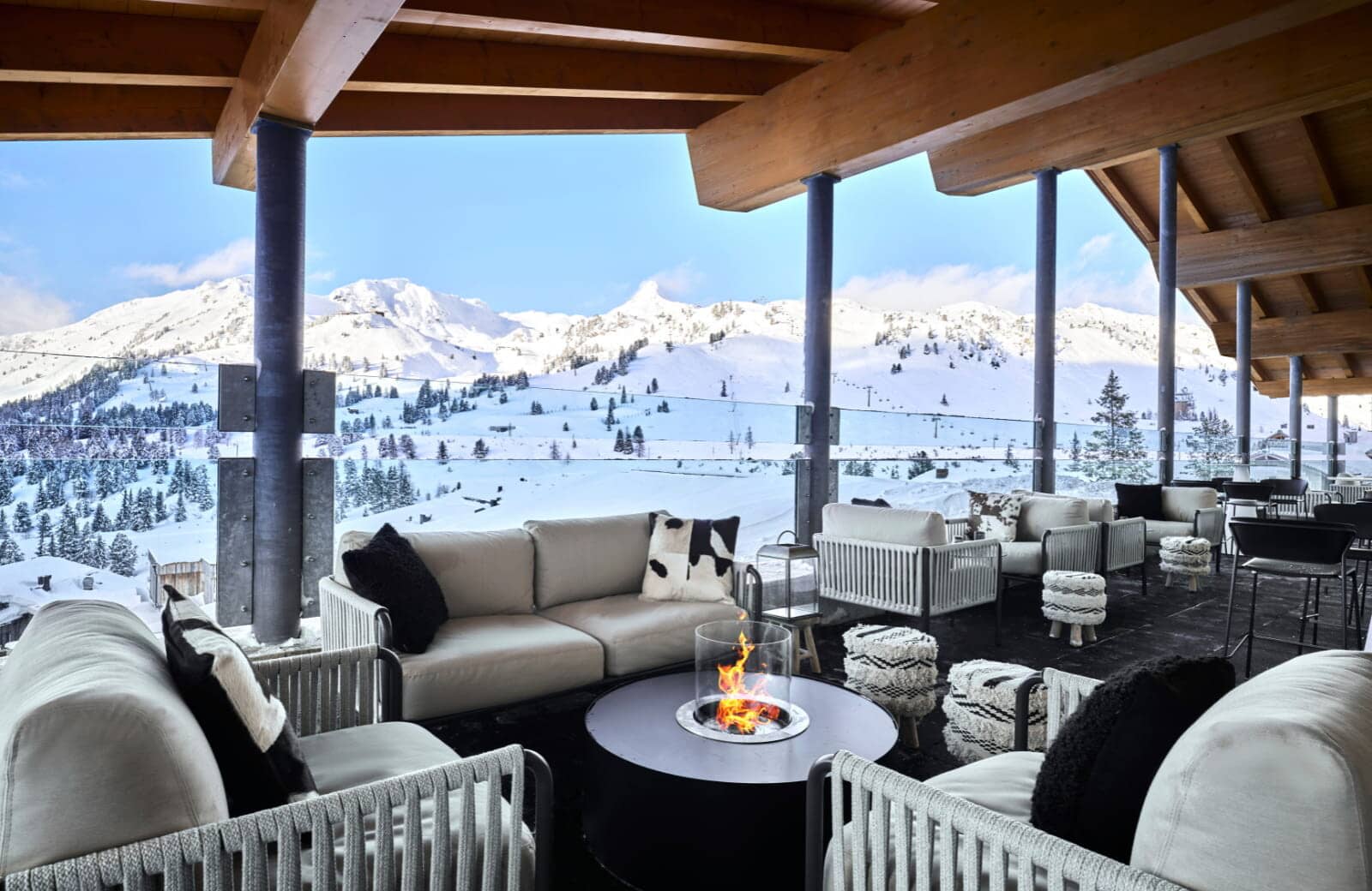 Covered terrace with gas fire pit and panoramic ski slope views