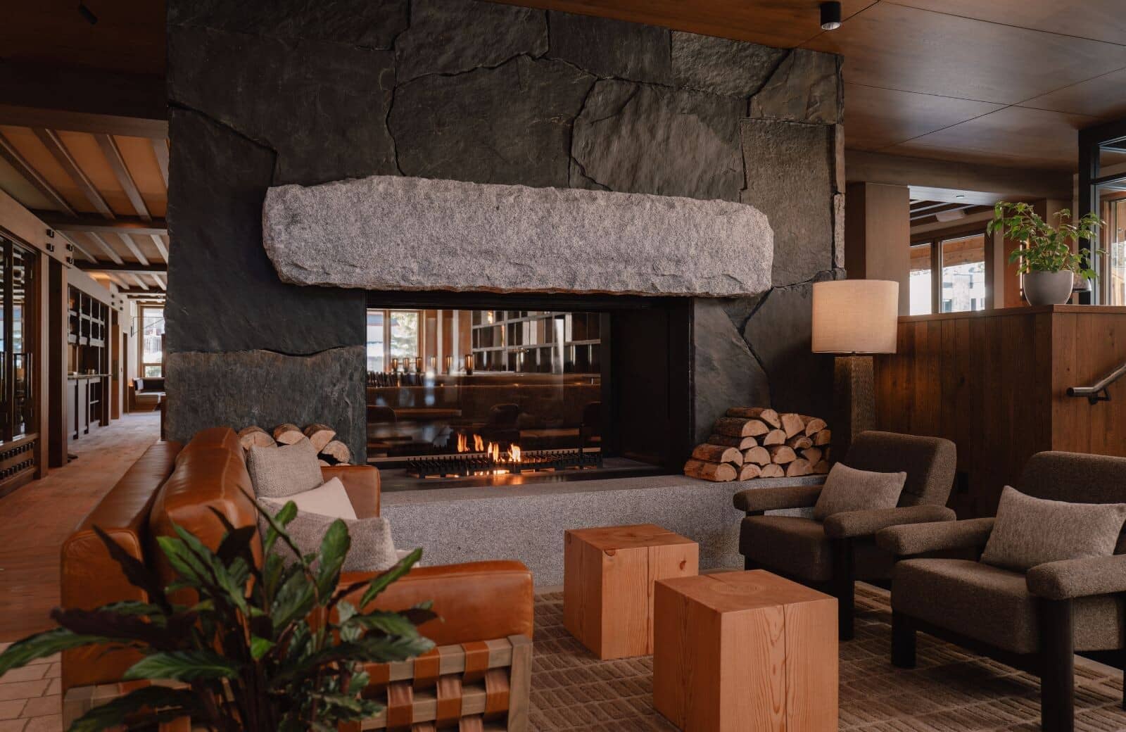Living area with double-sided stone fireplace and leather seating