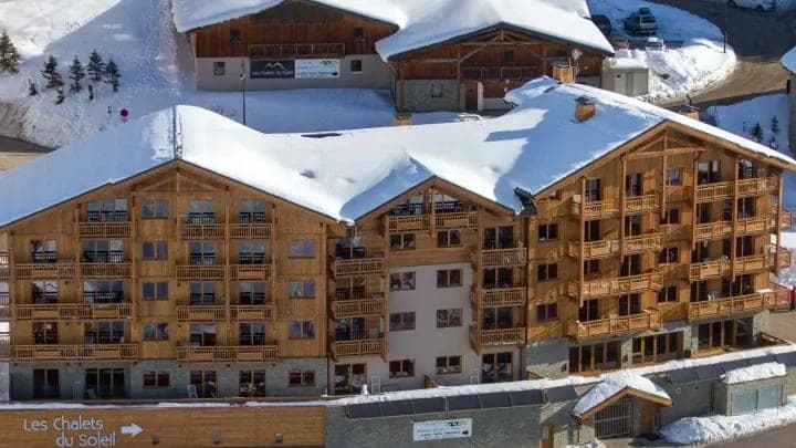 Ski-in, ski-out timber chalet with private balconies and snow-covered roof