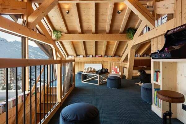 Loft game room with arcade machine, oversized chess set, and mountain views