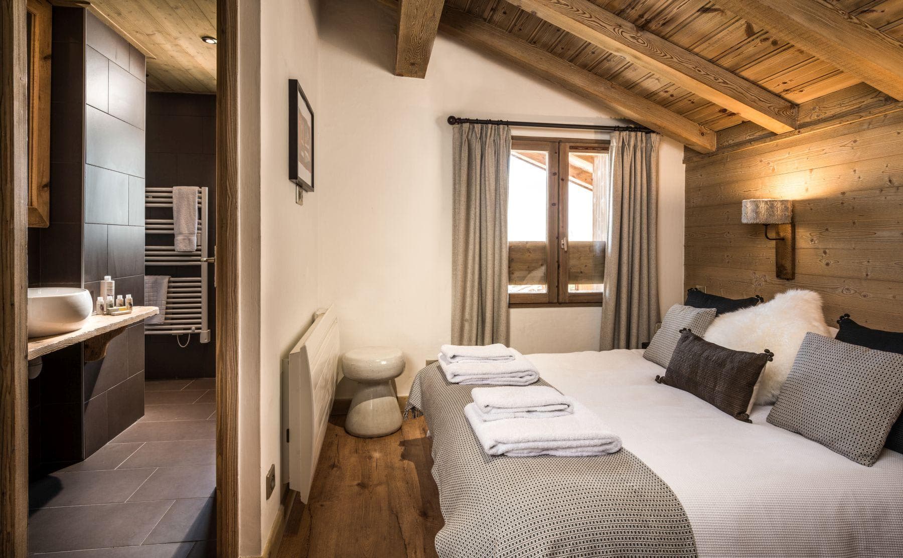 Ensuite bedroom with queen bed and heated towel rack