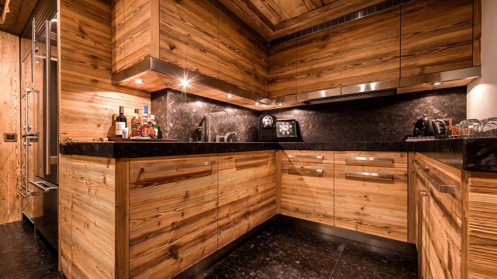 Kitchen with Nespresso machine, granite countertops, and integrated refrigerator