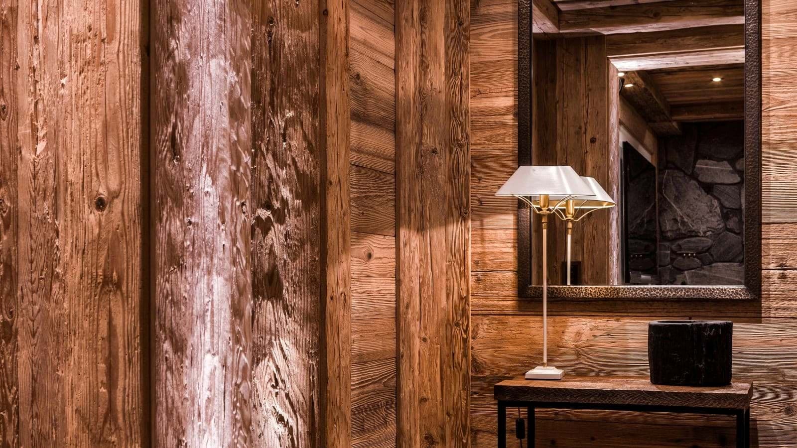 Entryway with reclaimed wood walls and hammered metal mirror frame